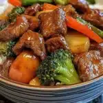 Colorful beef and veggie stir fry served in a bowl with chopsticks