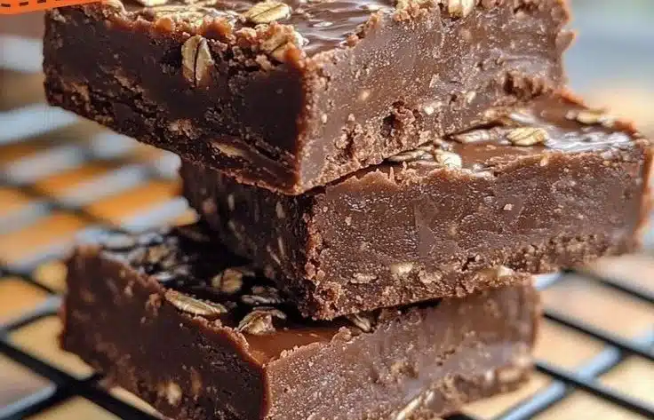 Indulgent Chocolate Oatmeal Fudge Bars 3 Indulgent chocolate oatmeal fudge bars on a wooden plate