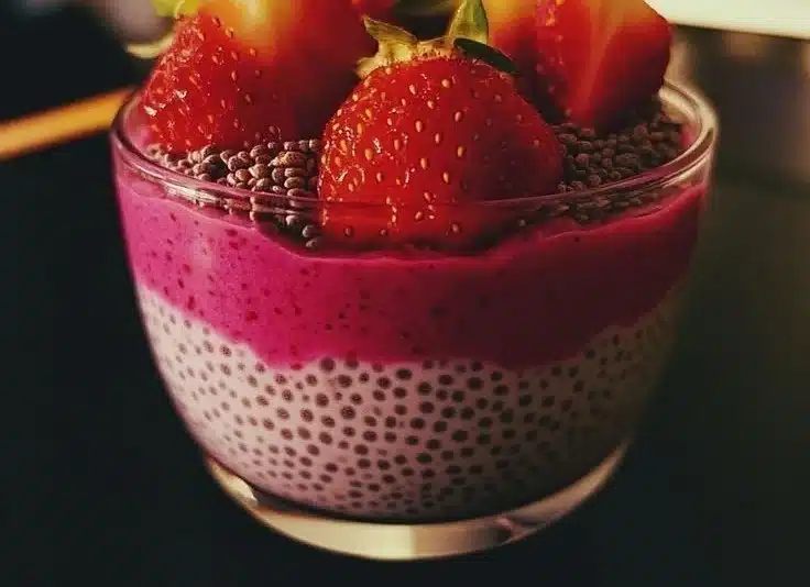 Delicious strawberry chia pudding topped with fresh strawberries and mint.